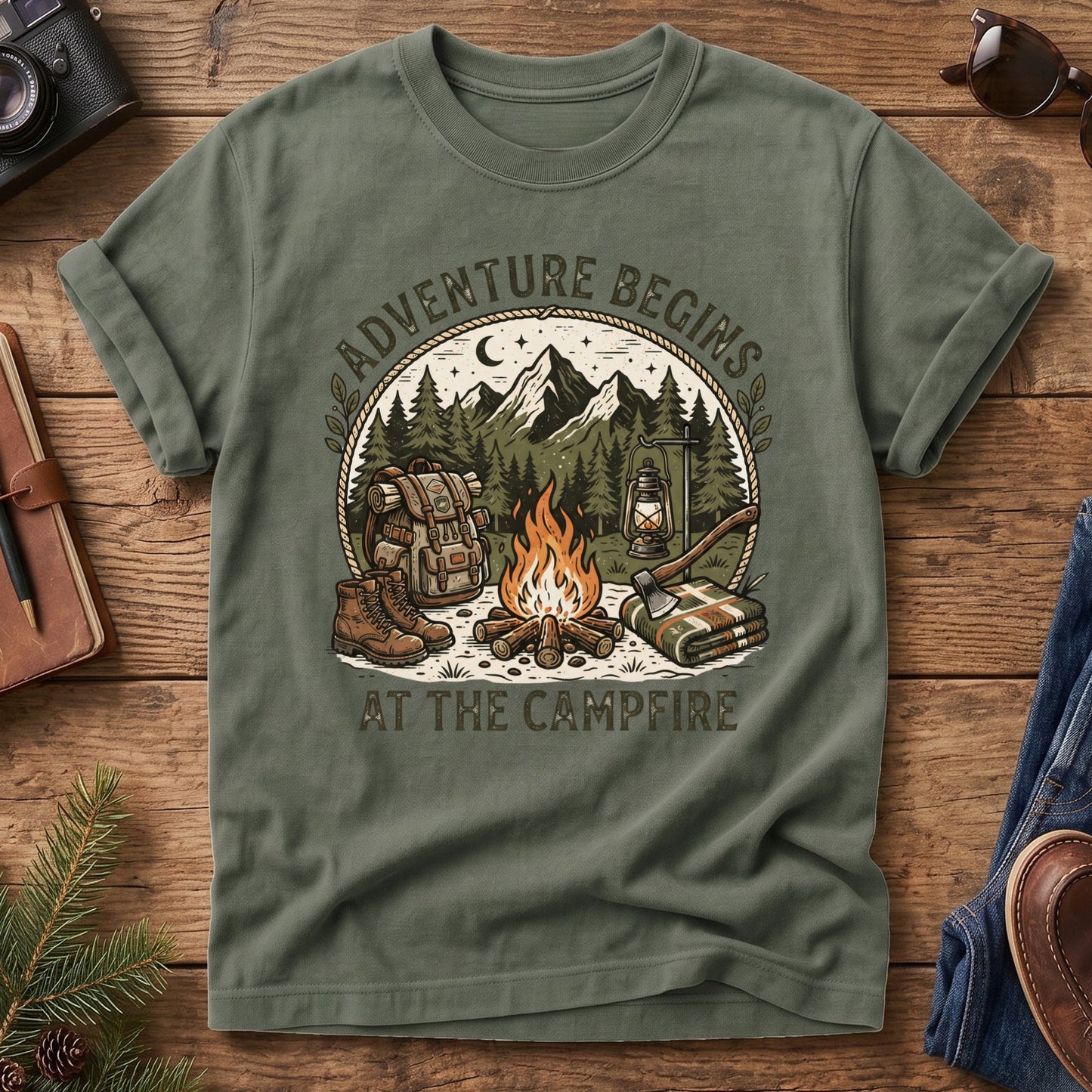 Adventure Begins Tee – styled flat lay, campfire badge graphic