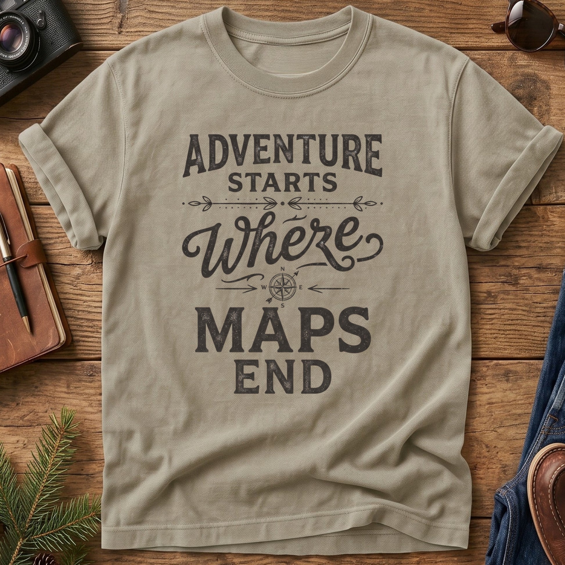 Adventure Starts Where The Maps End Tee – bold typography compass rose graphic on Comfort Colors 1717 tee, flat lay