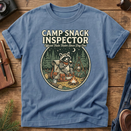 Camp Snack Inspector Tee – styled flat lay, raccoon campfire graphic