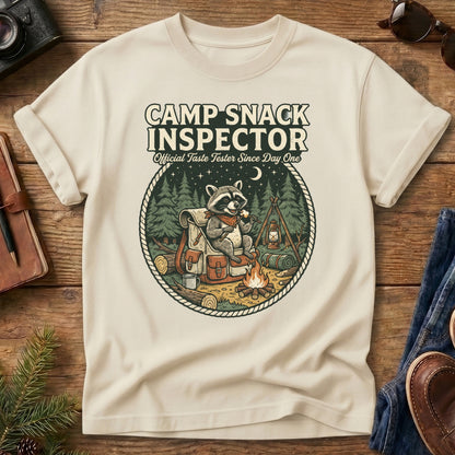 Camp Snack Inspector Tee – Ivory flat lay, raccoon campfire graphic
