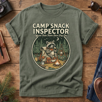 Camp Snack Inspector Tee – styled flat lay, raccoon campfire graphic