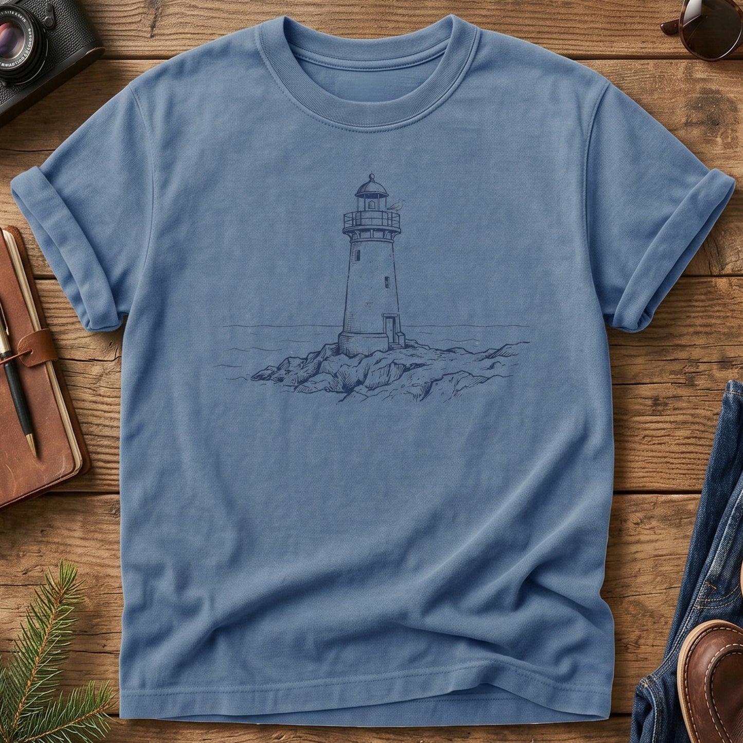 Coastal Lighthouse Tee in Blue Jean — fine-line lighthouse and coastline illustration