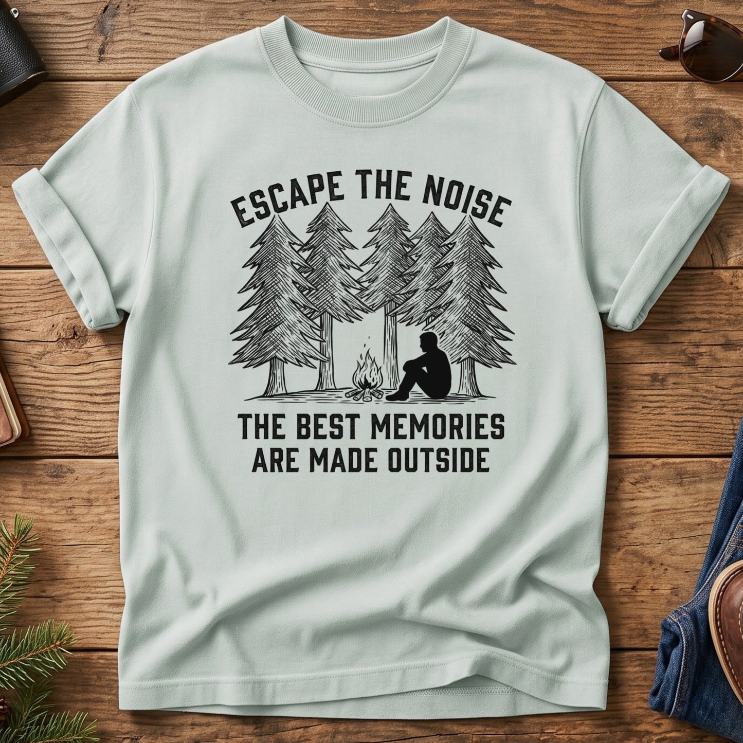 Escape The Noise Tee in Bay — campfire and pine tree graphic