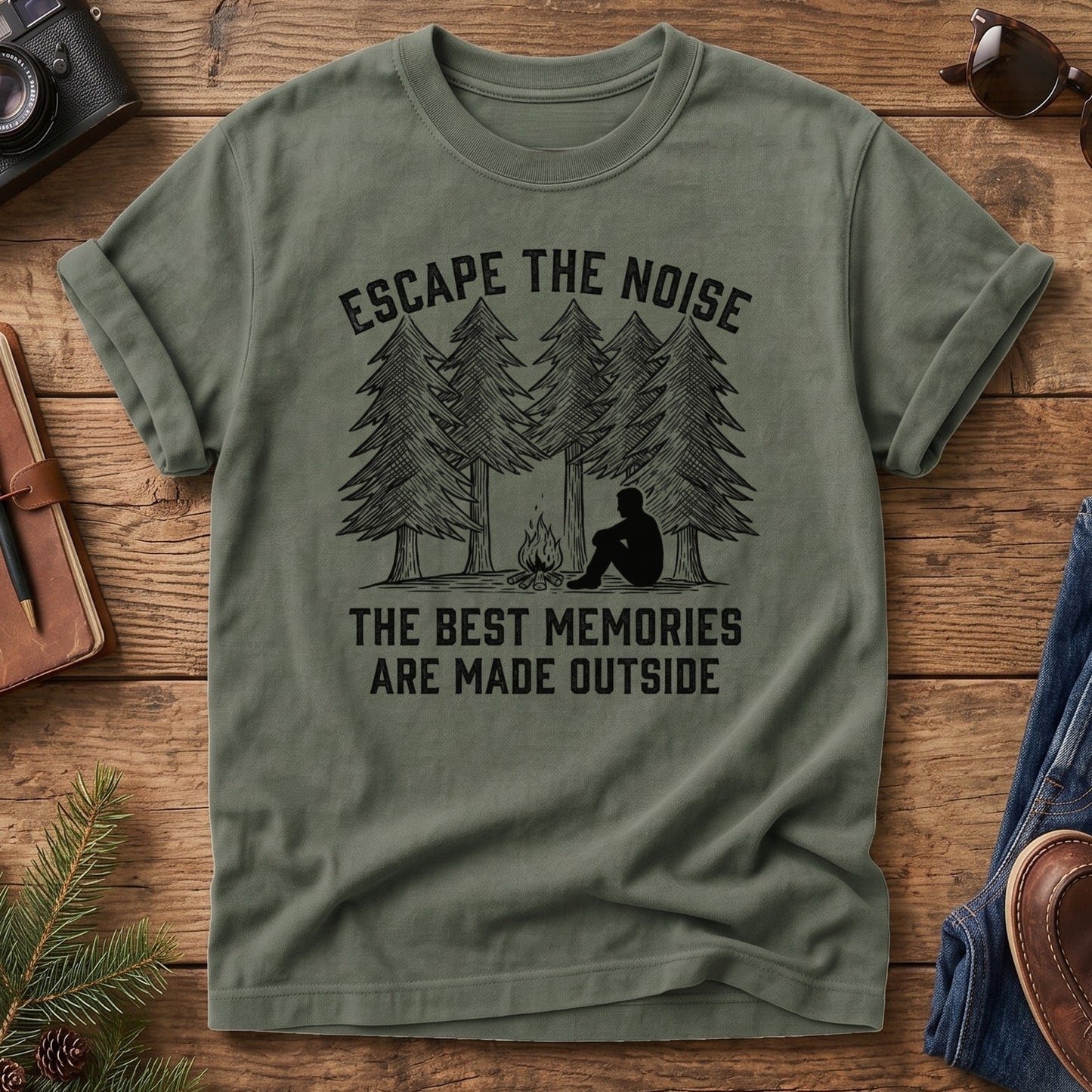 Escape The Noise Tee in Moss — campfire and pine tree graphic