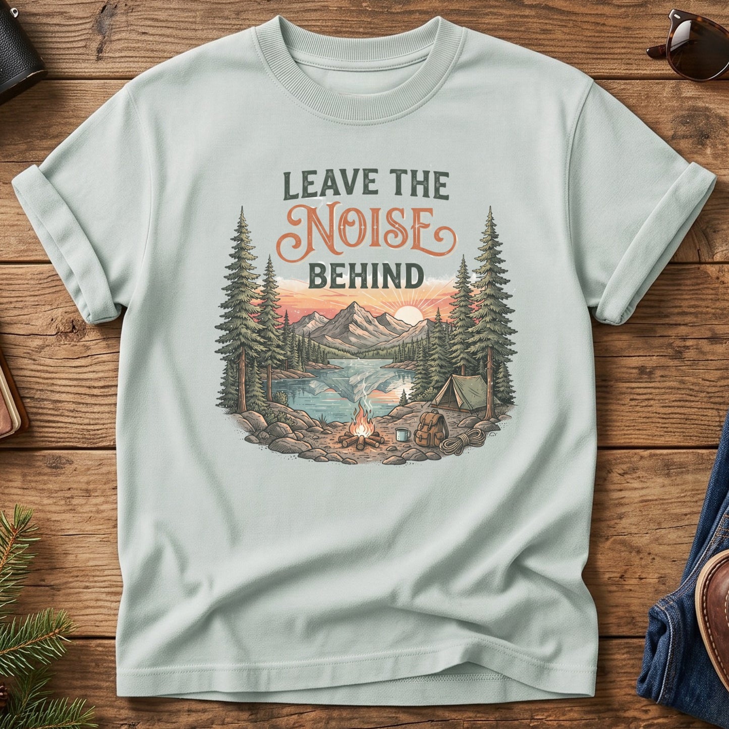 Leave the Noise Behind Tee – lakeside campsite with tent and campfire graphic on Comfort Colors 1717 tee, flat lay