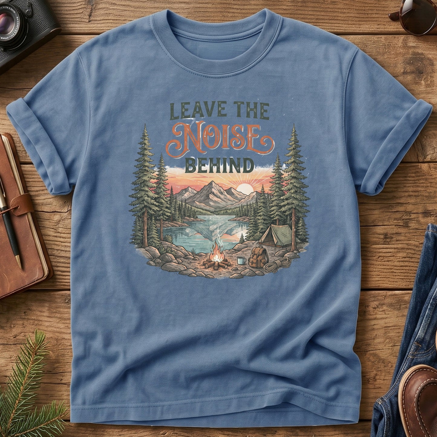 Leave the Noise Behind Tee – lakeside campsite with tent and campfire graphic on Comfort Colors 1717 tee, flat lay