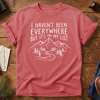 I Haven't Been Everywhere Tee in Watermelon — mountain and river wanderlust graphic with hand lettering