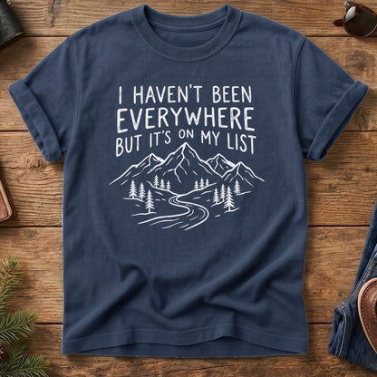 I Haven't Been Everywhere Tee in Navy — mountain and river wanderlust graphic with hand lettering