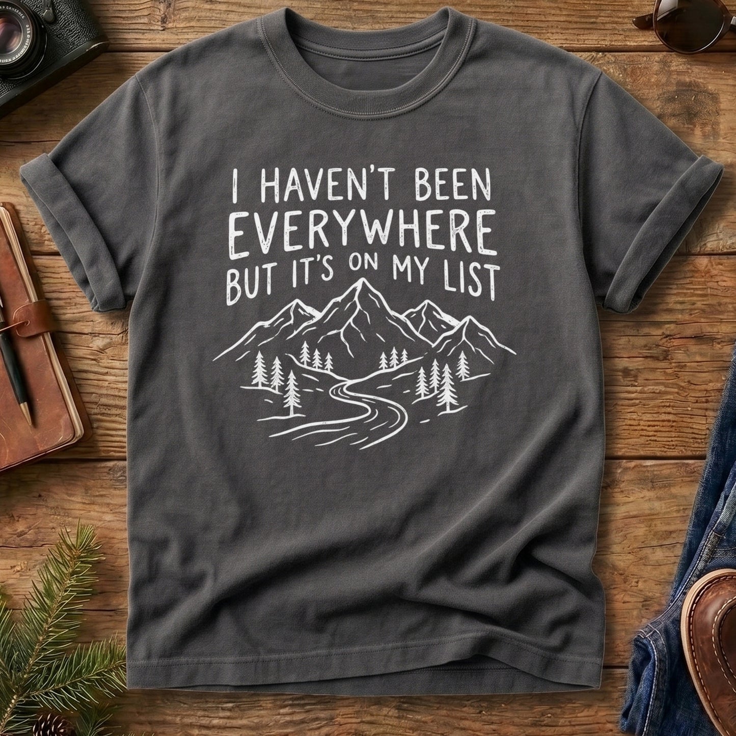 I Haven't Been Everywhere Tee in Grey — mountain and river wanderlust graphic with hand lettering