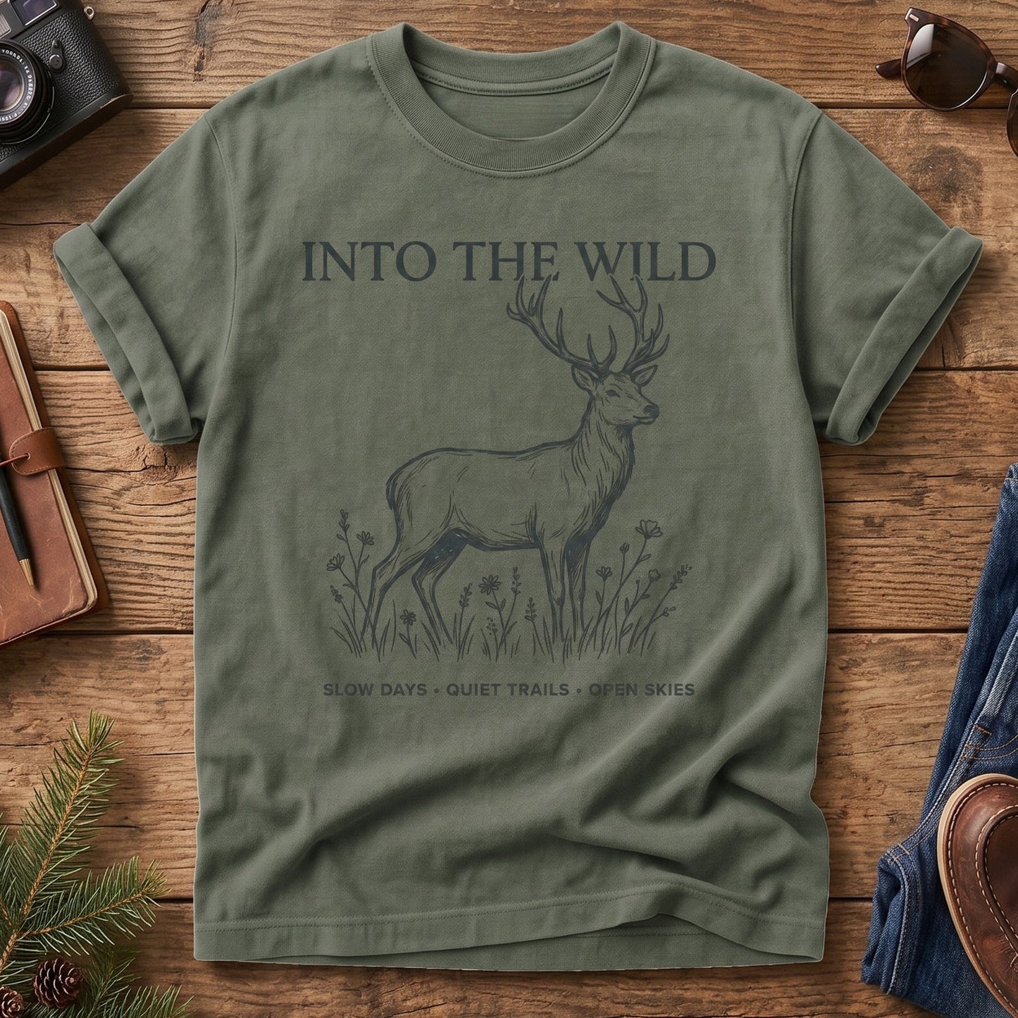 Into The Wild Tee in Moss — fine-line stag and wildflower graphic