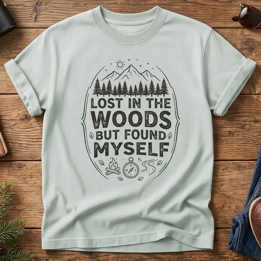 Lost In The Woods But Found Myself Tee in Bay — camp badge graphic with compass and campfire