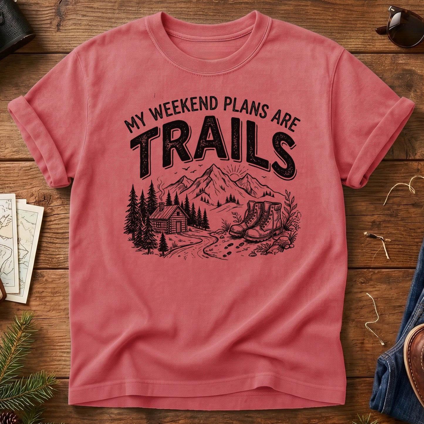 My Weekend Plans Are Trails Tee in Watermelon — cabin, mountain, and hiking boots graphic