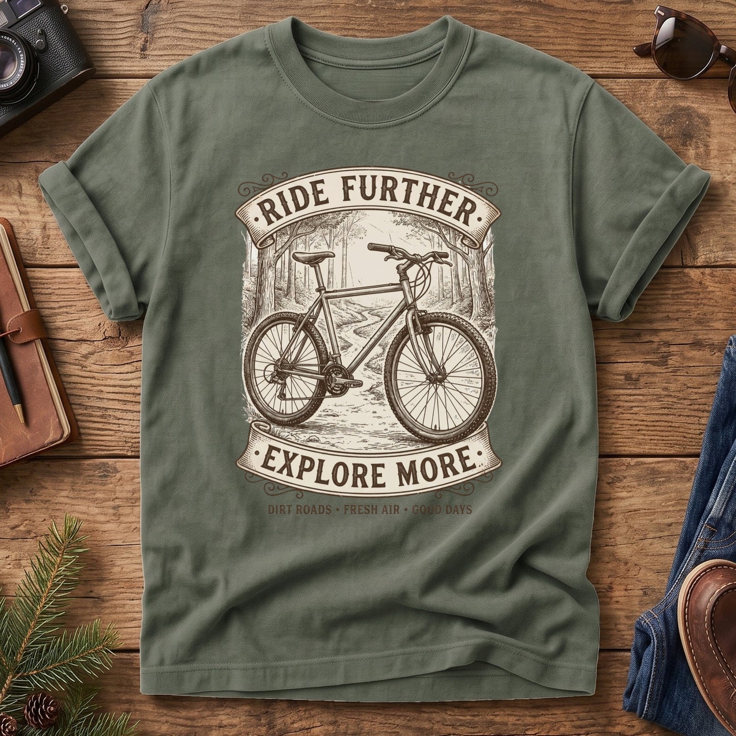 Ride Further, Explore More Tee in Moss — vintage mountain bike badge graphic