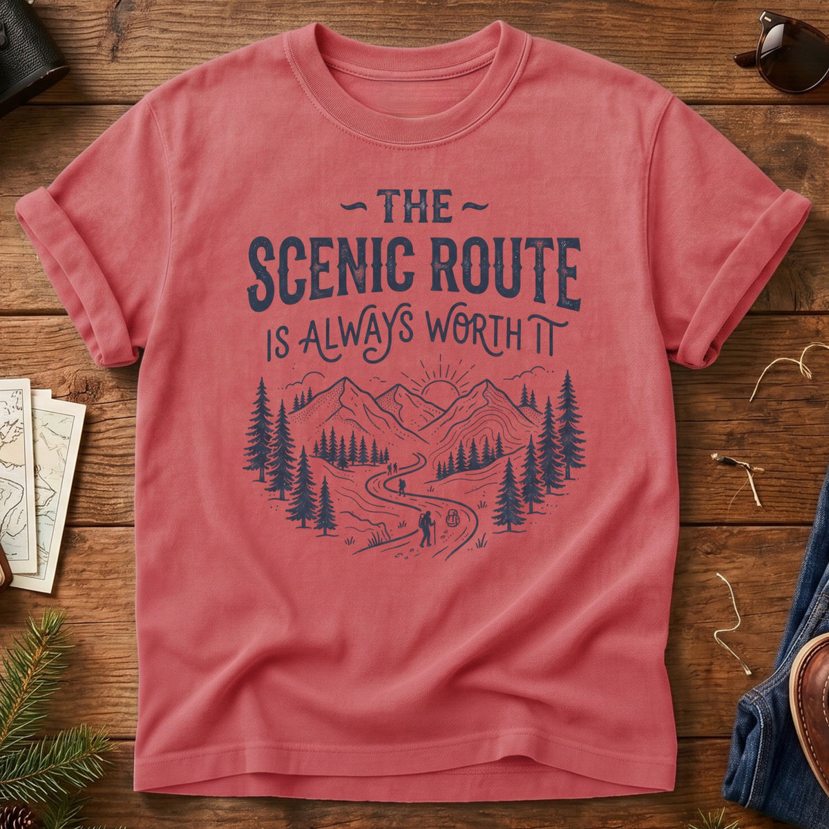 The Scenic Route Is Always Worth It Tee – hiker on winding mountain trail graphic on Comfort Colors 1717 tee, flat lay