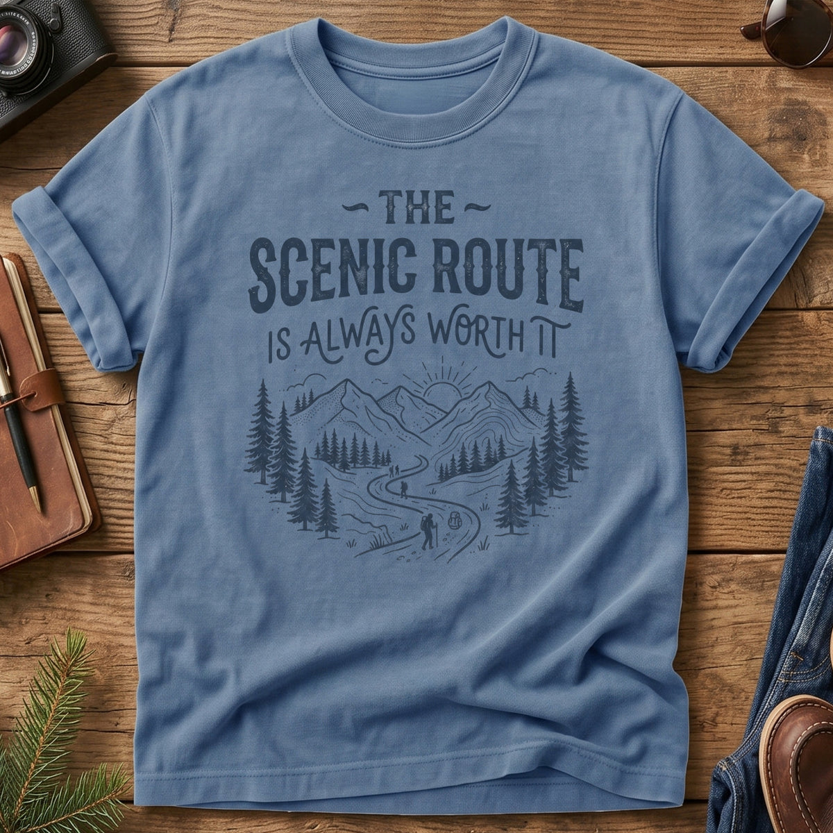 The Scenic Route Is Always Worth It Tee – hiker on winding mountain trail graphic on Comfort Colors 1717 tee, flat lay