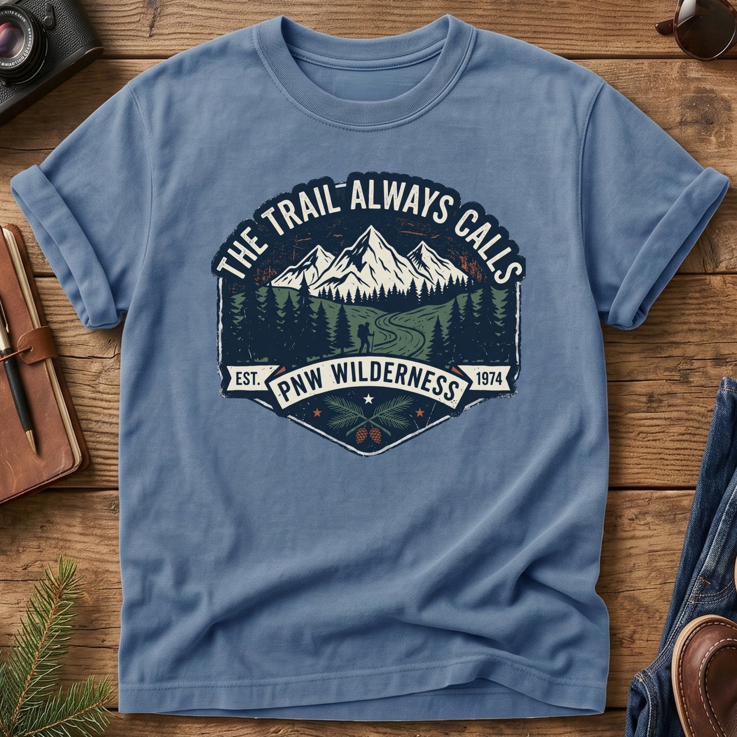 The Trail Always Calls Tee in Blue Jean — vintage mountain badge design