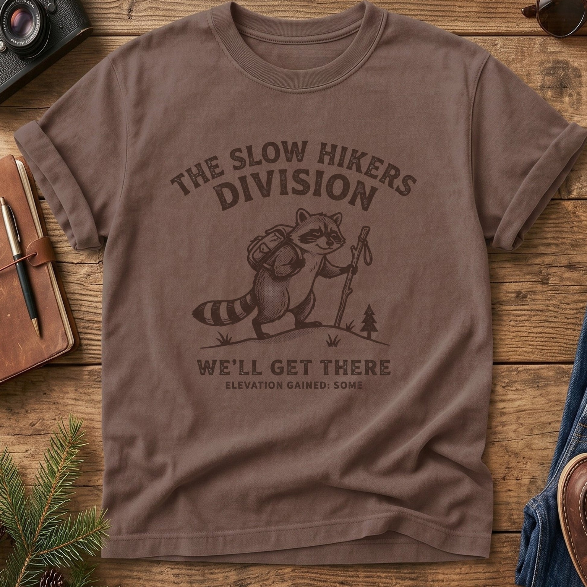 We'll Get There Slow Hikers Division Tee – close-up of Raccoon Trail Club graphic print
